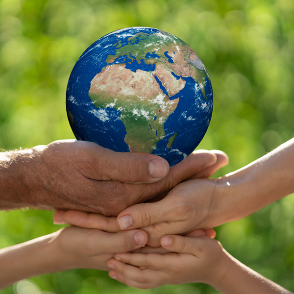 Family,Holding,3d,Planet,In,Hands,Against,Green,Blurred,Background.
