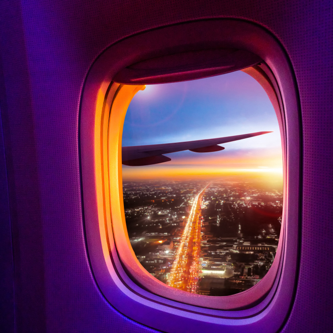 Beautiful,Scenic,City,View,Of,Sunset,Through,The,Aircraft,Window.